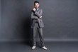 © opolja - Full length portrait of a fashion male model over grey background. Looking at camera.