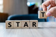 © Jo Panuwat D - Business man hand holding wooden cube with START text on table background. Goals, success, strategy, solution and business concepts