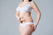© staras - Woman with fat abdomen, overweight female body on gray background