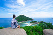 © oatautta - Woman sitting on a rock looking at the view beautiful Island Nangyuan Island, Thailand , Summer vacation .