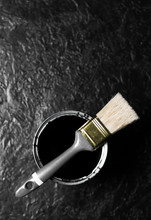 Brush And Open Can Black Color Of Paint On Black Background. Top View
