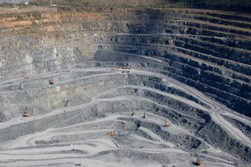 Wall Mural - Aerial view industrial of opencast mining quarry with lots of machinery at work