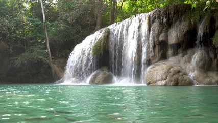 Wall Mural - Fish in the Erawan water fall (Second floor), tropical rainforest at Srinakarin Dam, Kanchanaburi, Thailand.Erawan water fall is beautiful waterfall in Thailand. Unseen Thailand
