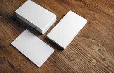 Photo of blank white business cards on wooden background. Template for ID.