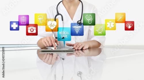 Hands Of Doctor Woman Touch Digital Tablet At Office Desk With