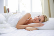 © lenets_tan - Pretty woman lying down on her bed at home