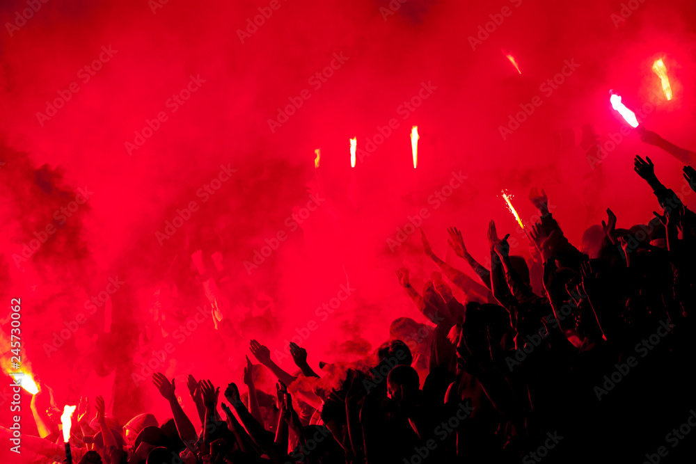 Football fans lit up the lights, flares and smoke bombs. Protest concept. - obrazy, fototapety, plakaty 