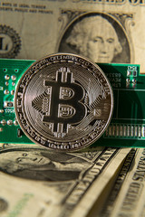 Wall Mural - silver bitcoin coin with dollars and computer motherboard, cryptocurrency mining and investing conce