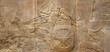 Assyrian relief of lions and warriors, ancient art of Mesopotamia. 