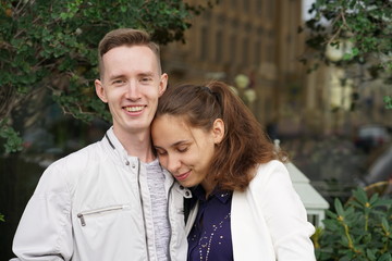 charming good couple husband and wife walking around the city, hugging and spending time with love