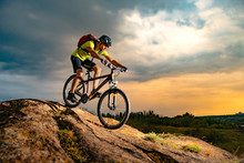 Cyclist Riding The Mountain Bike On Rocky Trail At Sunset. Extreme Sport And Enduro Biking Concept.