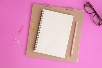 Wall Mural - blank notebook and pencil on pink background, flat lay photo of notebook for your message