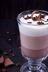 Layered dessert in an Irish glass mug with coffee and chocolate