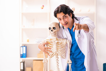 Young male doctor with skeleton 