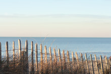 Wooden Fence And Sea At The Background.