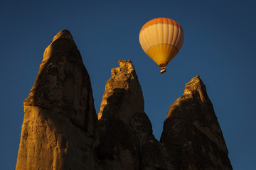 Colorful hot air balloon flying over a beatiful blue sky in background