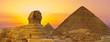canvas print picture - Sphinx against the backdrop of the great Egyptian pyramids. Africa, Giza Plateau.
