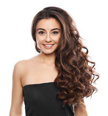 Wall Mural - Beautiful woman with shiny wavy hair on white background