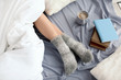© New Africa - Young woman lying on bed, closeup view of legs. Winter atmosphere