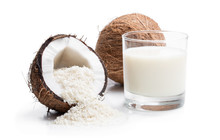 Glass Of Fresh Coconut Milk And Flakes Isolated On White