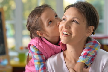 Poster - portrait of a charming little girl with mom 