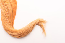 Human, Natural Honey-colored Blond Hair On White Isolated Background. Stylish, Fashionable Colors This Year. Honey Blonde Shaken, Wave And Undulating Hair. An Example Of Hairstyle.
