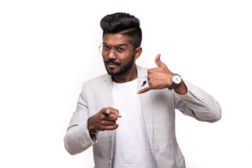 Canvas Print - Call me back please. Young attractive hipster indian man, makes phone sign, indicates with index finger directly at camera, wants to speak with someone via cell phone. Body language concept