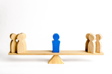 the leader stands on the scales between two groups of people. resolving conflict situations. the uni