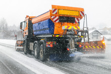 Snowplow Truck Removing Dirty Snow From City Street Or Highway During Heavy Snowfalls. Traffic Road Situation. Weather Forecast For Drivers. Seasonal Road Maintenance