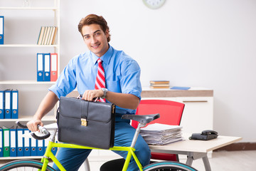 Young businessman using bike to commute to the office