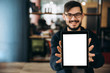 © Kateryna - Modern young guy with a beard and glasses is holding a tablet in his hands, in the office