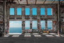 Abandoned  Factory Ruin  / Warehouse Loft With Windows And Ocean And Blue Sky Background  