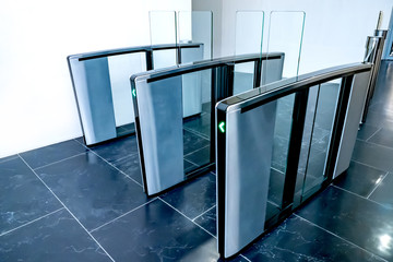 Turnstiles. Checkpoint. Automatic access control. Access system in the building. Automatic turnstile with sliding doors to control the flow of people. Entrance hall with turnstile