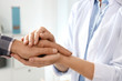 © New Africa - Female doctor comforting man on blurred background, closeup of hands. Help and support concept