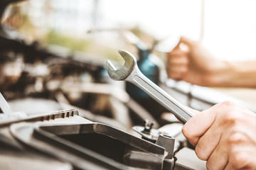 Wall Mural - Auto mechanic working in garage Technician Hands of car mechanic working in auto repair Service and Maintenance car check.