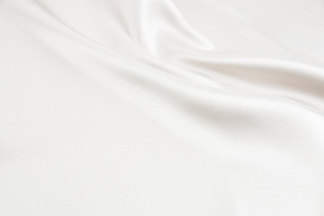 The texture of the satin fabric of white color for the background