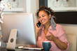 © digitalskillet1 - Mixed race woman working from her home office.