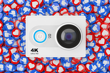 Aufkleber - Small Ultra HD Action Camera over Heap of Social Media Network Love and Like Heart Badges Coins Background Texture. 3d Rendering