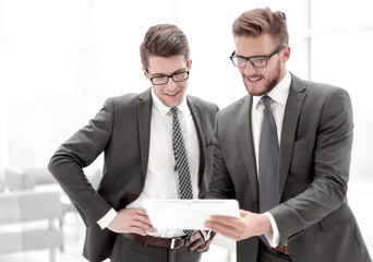 Wall Mural - two colleagues looking at the digital tablet screen