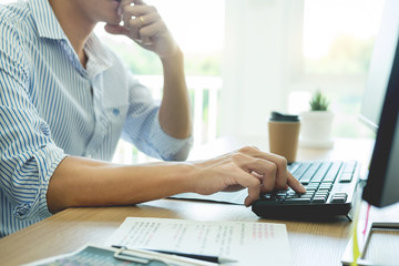serious busy hipster young web software developer programmer is coding or programming on a desktop c