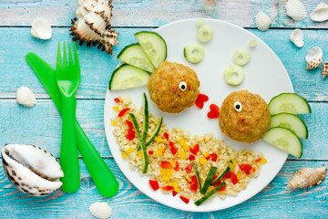 Food art idea healthy lunch for kids chicken meatballs with bulgur porridge and fresh vegetables shaped cute fishes