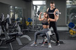 © serhiibobyk - Couple training together in gym.