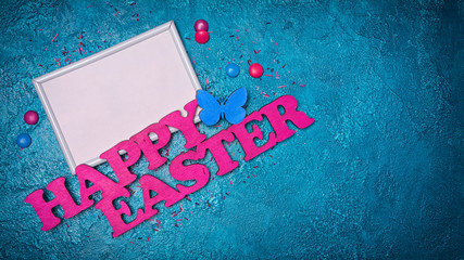 Canvas Print - Mock up of blank white frame with pink text of happy easter and colorful dragee with sugar sprinkles