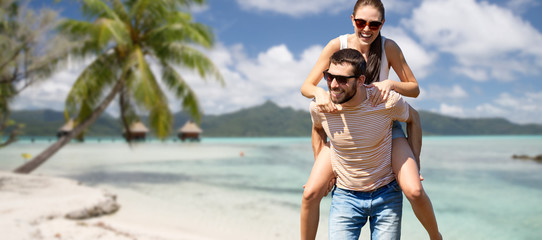 Sticker - travel, tourism and people concept - happy couple having fun in summer over tropical beach background in french polynesia