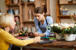 Portrait of two female business owners managing flower shop, copy space