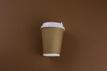 Wall Mural - disposable paper cups on a brown background