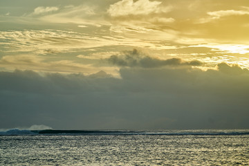 A perfect wave breaks over the reef in black river on the island of Mauritius. A storm from out to sea created some bog swell amazing light over the ocean.