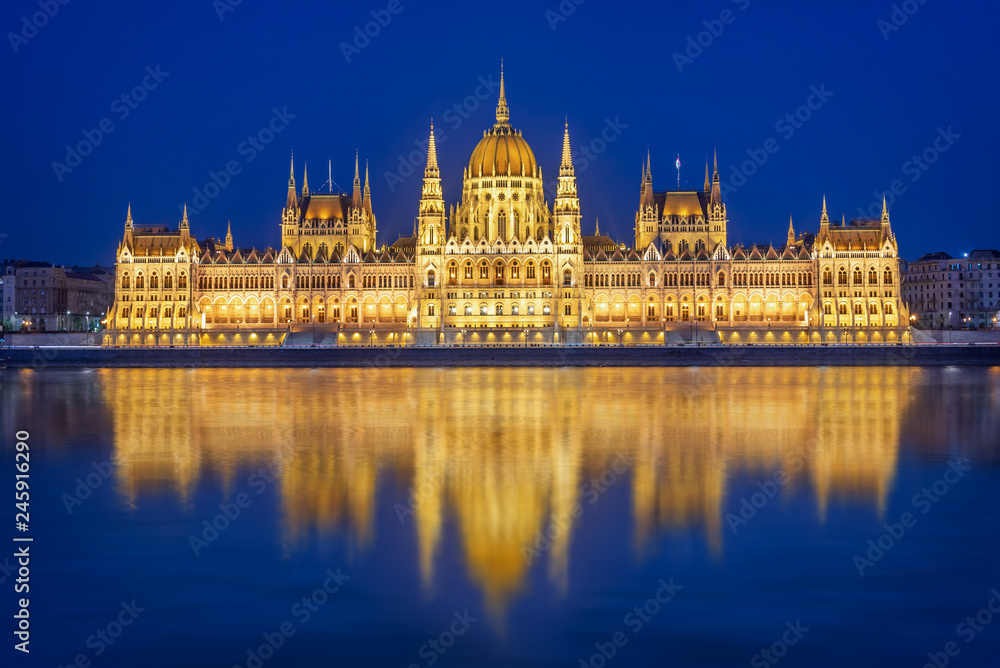 Budapest parliament illuminated at night and Danube river, Hungary - obrazy, fototapety, plakaty 