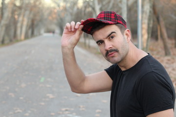 Wall Mural - Man with moustache saluting with a cap 