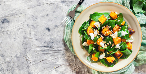 Wall Mural - Roasted pumpkin salad with spinach and nuts